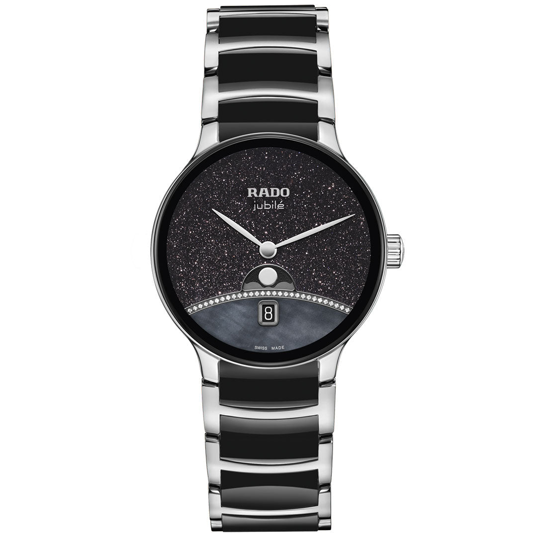 The RADO Centrix Moonphase Quartz 35mm Watch features a silver and black high-tech ceramic band, round black glittery dial with silver hands, date window at 6 o'clock, and decorative stones on the lower half.