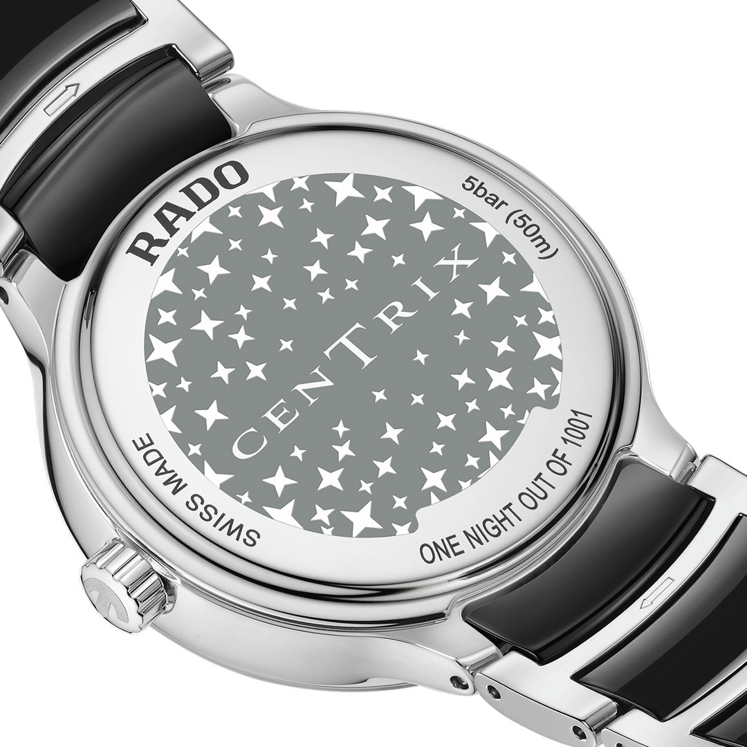 Close-up of the back of the RADO Centrix Moonphase Quartz 35mm Watch, a limited edition with "5 bar (50m)", "SWISS MADE", and "ONE NIGHT OUT OF 1001" engraved amid many stars on its high-tech ceramic case.