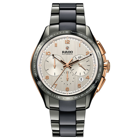The RADO HyperChrome Automatic 45mm Watch showcases a sleek blend of stainless steel and black ceramic in its bracelet. It includes a silver dial adorned with three subdials, a date window, rose gold-tone accents, and features a tachymeter scale on the bezel—making it an ideal accessory for any business suit.