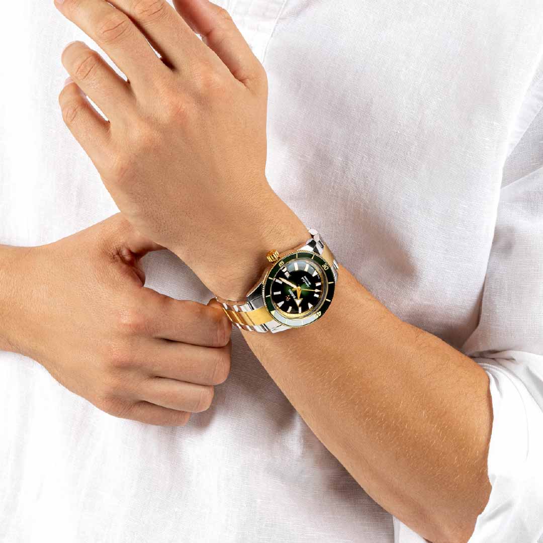 The individual, with a light skin tone, is dressed in a white, long-sleeved shirt and precisely adjusting their RADO Captain Cook Automatic 42mm watch, featuring a black dial with gold and silver accents.