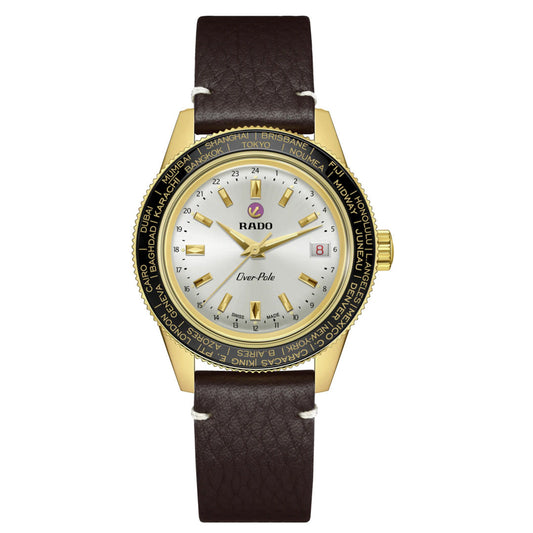 The RADO Captain Cook Over-Pole Limited Edition Handwinding 39mm Watch features a round gold case, white dial, gold markers, date window, brown leather strap, and world cities bezel—powered by a manual-winding Worldtimer movement.