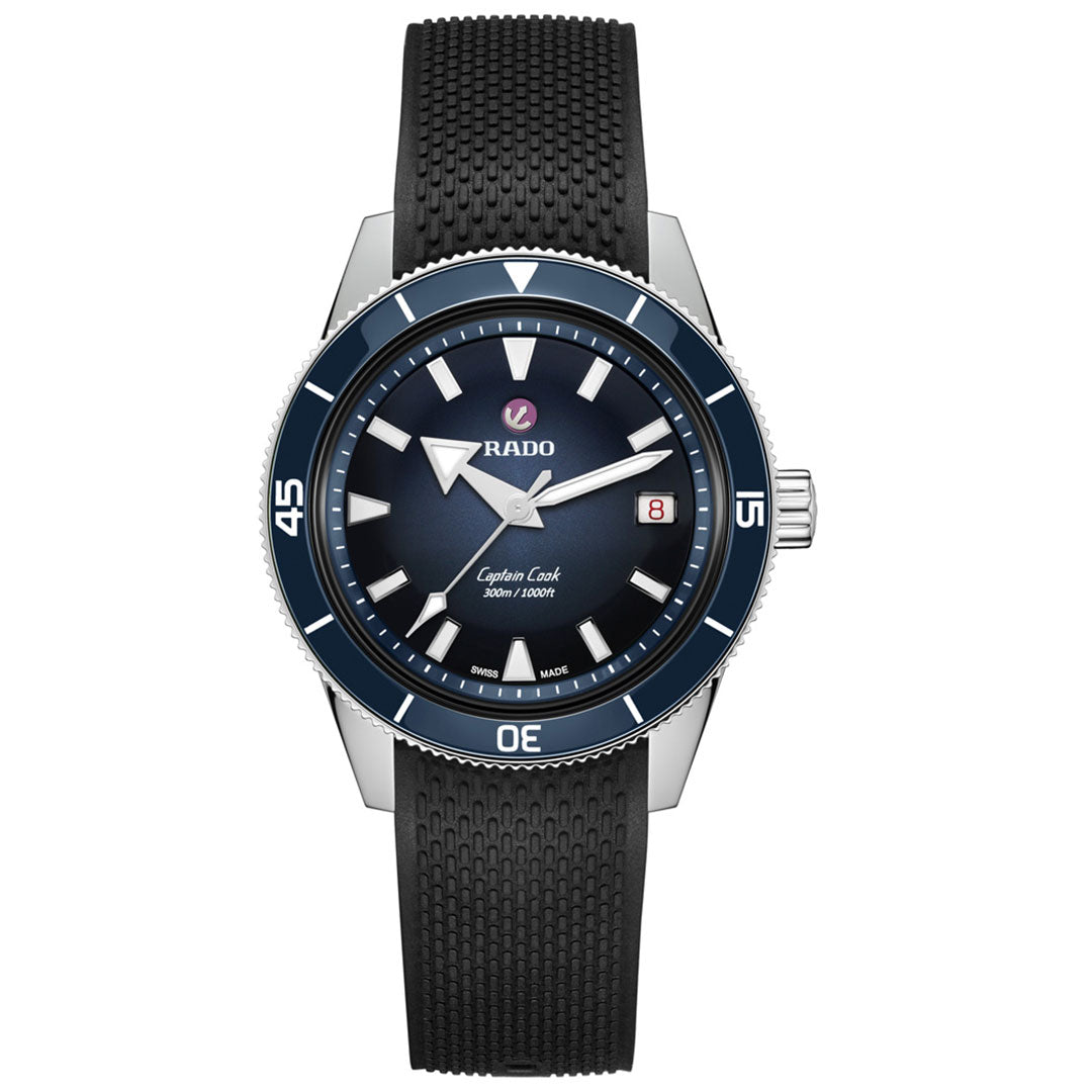 The RADO Captain Cook Automatic 39mm Watch features a black textured strap, blue ceramic bezel, and blue gradient dial with bold luminous markers and hands. The date display sits at 3 o’clock for easy readability.