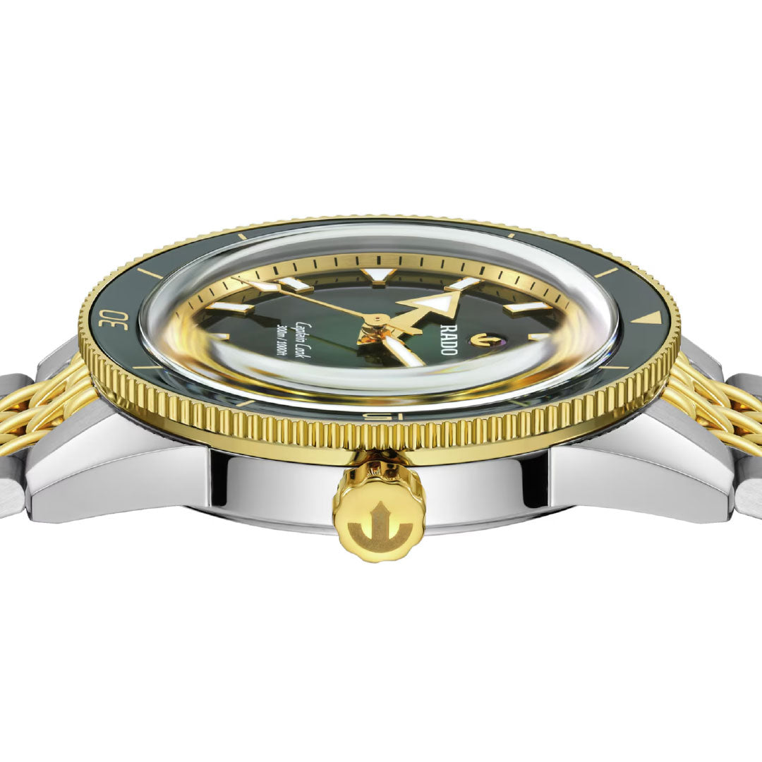Side view of the RADO Captain Cook Automatic 39mm watch, featuring a gold and silver metal band, green and gold bezel, and gold crown with anchor symbol—showcasing detailed craftsmanship from RADO.