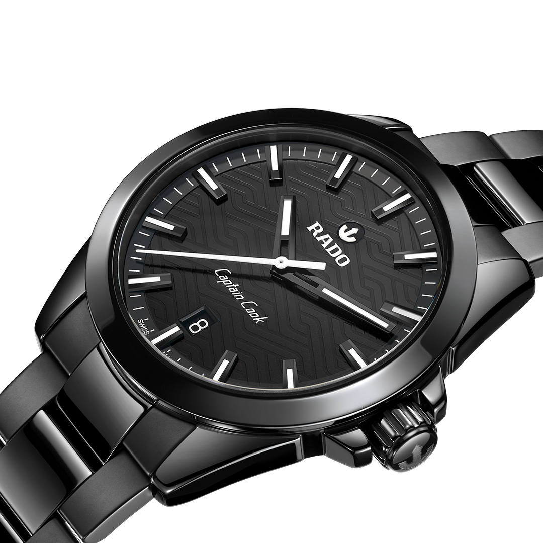RADO Captain Cook Discover Automatic 40.7mm Watch in black high-tech ceramic, featuring a patterned dial, silver hands and indices, a date window at the six o’clock position, and a matching black link bracelet.