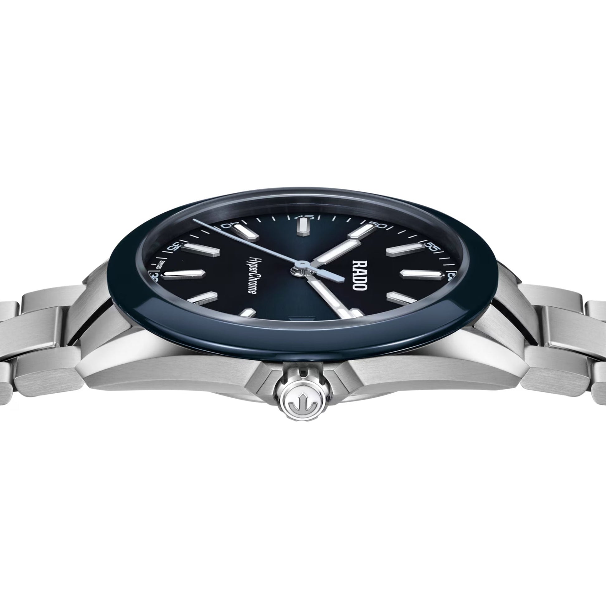 The RADO HyperChrome Quartz 41.5mm Watch by RADO features a silver case, dark blue face and high-tech ceramic bezel, silver hour markers, and a metal link band, shown from the side to highlight its crown and sleek design.