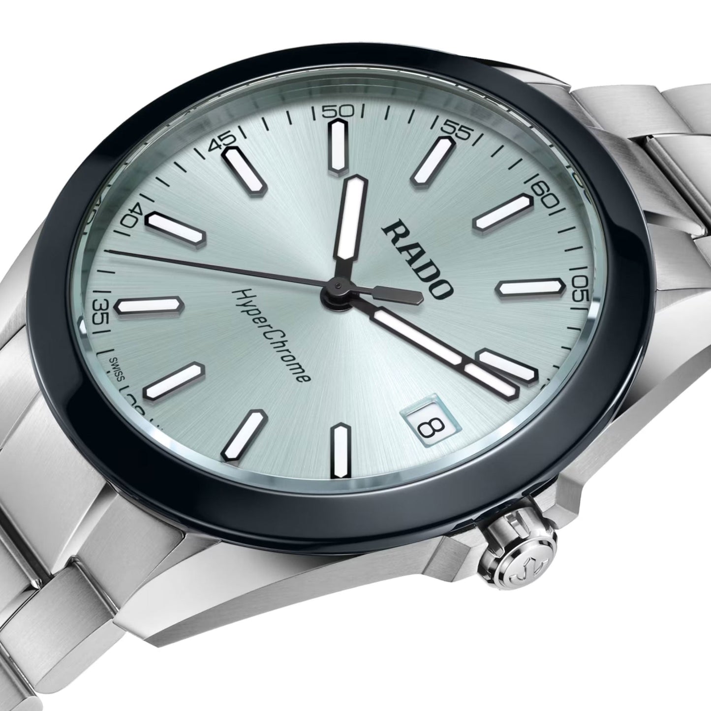 A close-up of the RADO HyperChrome Quartz 41.5mm Watch features a silver metal band, light blue dial, high tech ceramic bezel, silver hour markers, black hands, and a date display at 3 o’clock.