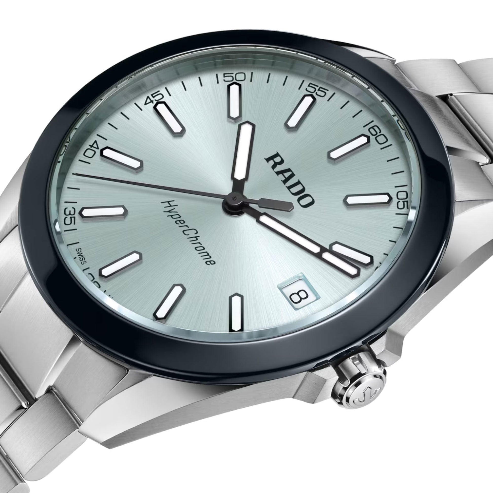 A close-up of the RADO HyperChrome Quartz 41.5mm Watch features a silver metal band, light blue dial, high tech ceramic bezel, silver hour markers, black hands, and a date display at 3 o’clock.