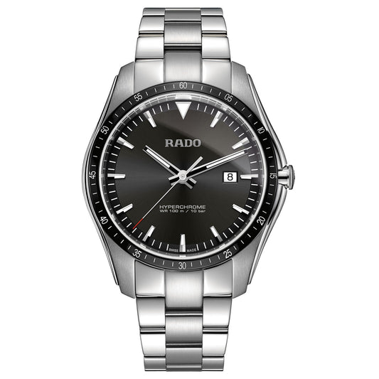 The RADO HyperChrome Quartz 44mm watch features a versatile silver design with a black dial, complemented by silver hour markers and a date display at the 3 o'clock position. Its sleek, modern aesthetic is enhanced by a high-tech ceramic and stainless steel bracelet, making it suitable for any occasion.