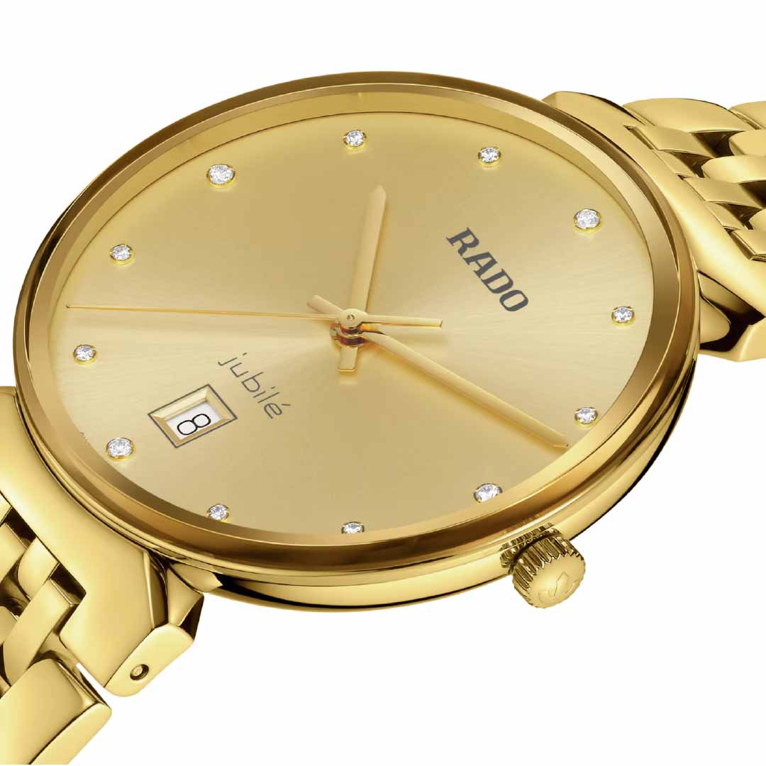 A close-up of the RADO Florence Diamonds Quartz 38mm Watch showcases its yellow gold finish, distinguished by diamond-like hour markers and a date display set to the 8th. The sleek design is complemented by a polished gold bracelet, bringing an elegant touch to this exquisite timepiece from RADO.