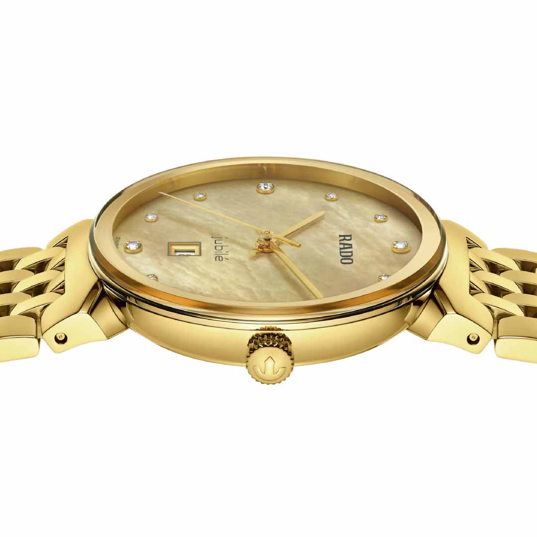 The RADO Florence Diamonds Quartz 30mm Watch, a luxurious timepiece in yellow gold, showcases a gold dial adorned with diamond hour markers and a date window at the 3 o'clock position, with the RADO brand name elegantly displayed. This exquisite watch is powered by quartz movement and features a gold link bracelet along with a intricately detailed crown.