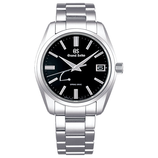 The Grand Seiko Heritage Collection Spring Drive 40mm watch features a sleek stainless steel case, silver metal band, black dial with diamond-cut hands, silver hour markers, and a date display at 3 o'clock. Its "Spring Drive" text accompanies the remarkable Spring Drive movement.