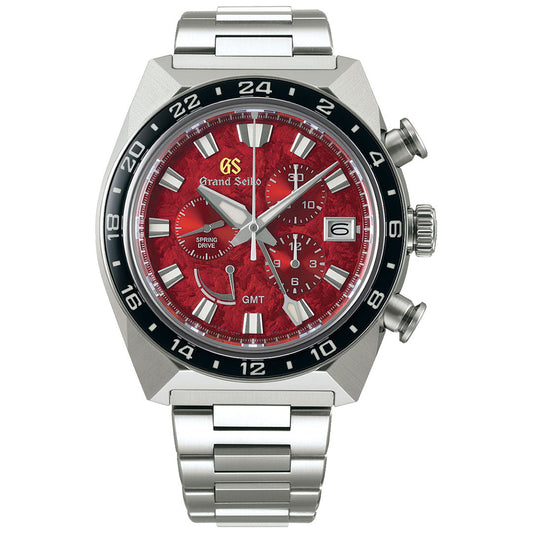 The Grand Seiko Sport Collection Spring Drive Chronograph GMT 44.5mm Watch, a Caliber 9R 20th Anniversary Limited Edition of just 700 pieces, features a striking red dial with hour, minute, and second hands. It includes a date window at the 3 o'clock position, a black bezel, two sub-dials, and prominently displays the "GS Grand Seiko" logo. The watch is complemented by a polished metal band and incorporates cutting-edge Spring Drive technology.