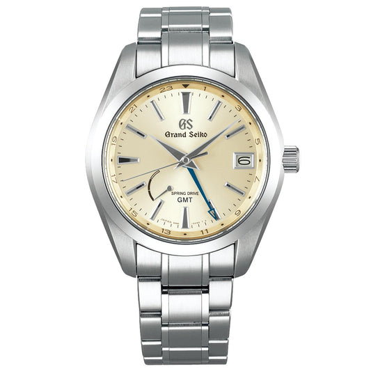 The Grand Seiko Heritage Collection Spring Drive GMT 41mm Watch showcases a stainless steel band and a champagne-colored face. It includes a date window, a GMT hand, and a power reserve indicator. The metallic hour markers and hands harmonize beautifully with the polished silver bezel, enhancing its timeless elegance.