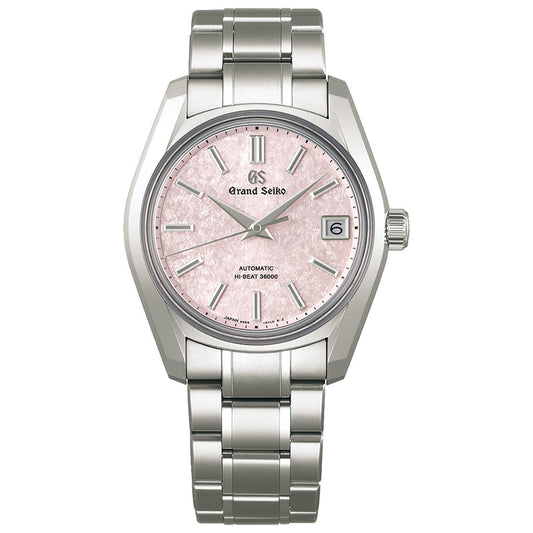 The Grand Seiko Heritage Collection Automatic with Manual Winding 38mm Watch features a silver metal band and case, a textured pink dial, and silver hour markers. It is equipped with the Hi-Beat Caliber 9S85 for precision, and the date is displayed at the 3 o'clock position with "Automatic Hi-Beat 36000" prominently labeled.