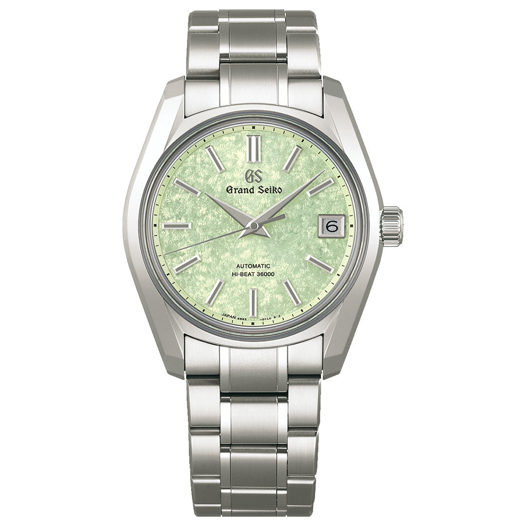 The Grand Seiko Heritage Collection Automatic with Manual Winding 38mm Watch features a high-intensity titanium construction, a silver metal bracelet and case, and boasts a textured green dial with silver hour markers and hands. It is equipped with a date window at the 3 o'clock position. The Grand Seiko brand name is elegantly displayed beneath the 12 o'clock mark.