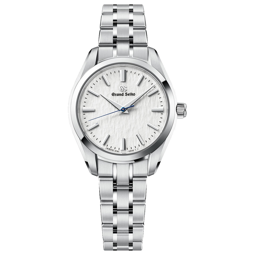 Introducing the Grand Seiko Heritage Collection 9F51 Quartz 33mm Watch by Grand Seiko, featuring a silver stainless steel band and case with a textured white dial inspired by the Hotaka mountain range. Silver hour markers and hands are complemented by a striking blue second hand, while the precision Caliber 9F51 movement ensures both elegance and reliability.