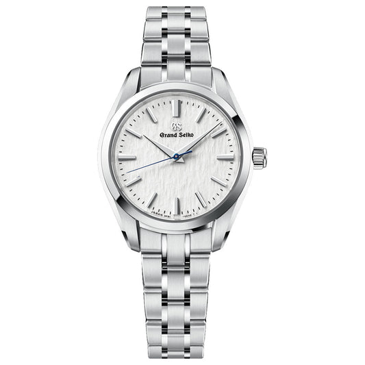 Introducing the Grand Seiko Heritage Collection 9F51 Quartz 33mm Watch by Grand Seiko, featuring a silver stainless steel band and case with a textured white dial inspired by the Hotaka mountain range. Silver hour markers and hands are complemented by a striking blue second hand, while the precision Caliber 9F51 movement ensures both elegance and reliability.
