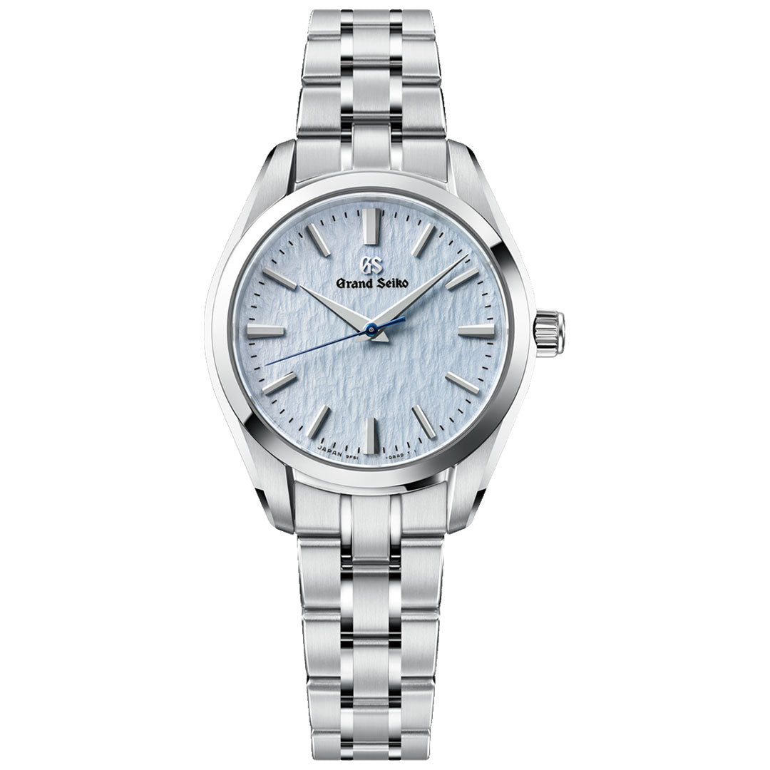 The Grand Seiko Heritage Collection 9F51 Quartz 33mm Watch by Grand Seiko features a stainless steel band and a light blue textured dial with silver hands and indices, displayed on a white background. Powered by the esteemed Caliber 9F51 quartz movement, this timepiece showcases Grand Seiko’s renowned craftsmanship and precision.