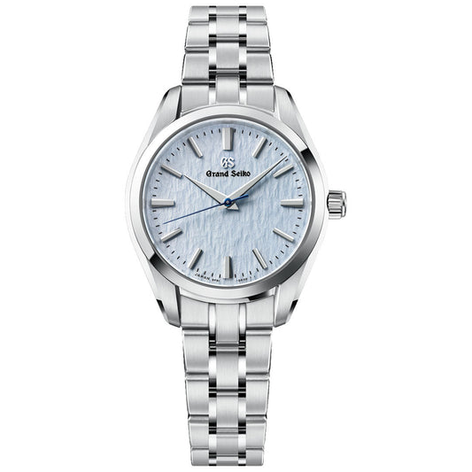 The Grand Seiko Heritage Collection 9F51 Quartz 33mm Watch by Grand Seiko features a stainless steel band and a light blue textured dial with silver hands and indices, displayed on a white background. Powered by the esteemed Caliber 9F51 quartz movement, this timepiece showcases Grand Seiko’s renowned craftsmanship and precision.