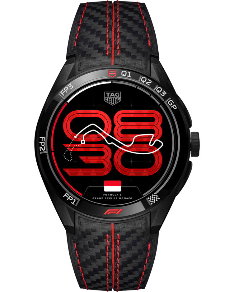 The TAG Heuer Connected Calibre E5 x Formula 1® Edition 45mm Smart Watch features a black case, striking red accents, and a racing-inspired watch face displaying a Monaco GP track map alongside digital time. It comes with a carbon fiber-textured strap finished with bold red stitching.