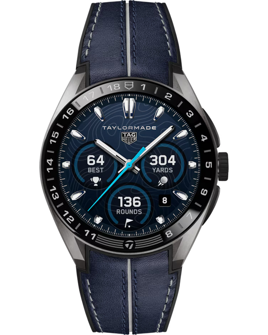 The TAG Heuer Connected Calibre E5 x TaylorMade Edition 45mm Smart Watch features a blue leather strap and displays golf stats such as a best score of 64, 304 yards, and 136 rounds played. The watch face is accented with silver indexes, three subdials, and “TAYLORMADE” branding at the top.