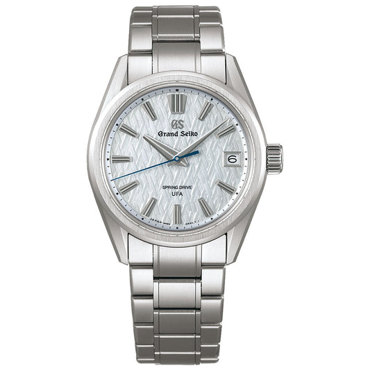 The Grand Seiko Evolution 9 Collection Spring Drive 37mm Watch features a textured white dial, silver hour markers and hands, Spring Drive Caliber 9RB2, "U.S. Exclusive Edition" on the dial, and a date window at 3 o’clock.