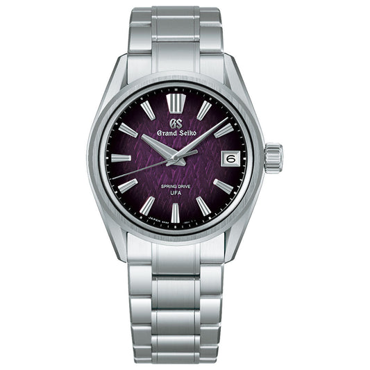 The Grand Seiko Evolution 9 Collection Spring Drive 37mm Watch, a limited edition of 1,300 pieces, features a silver metal bracelet, purple textured dial with silver markers, date at 3 o’clock, and Caliber 9RB2 for ultra-fine accuracy.