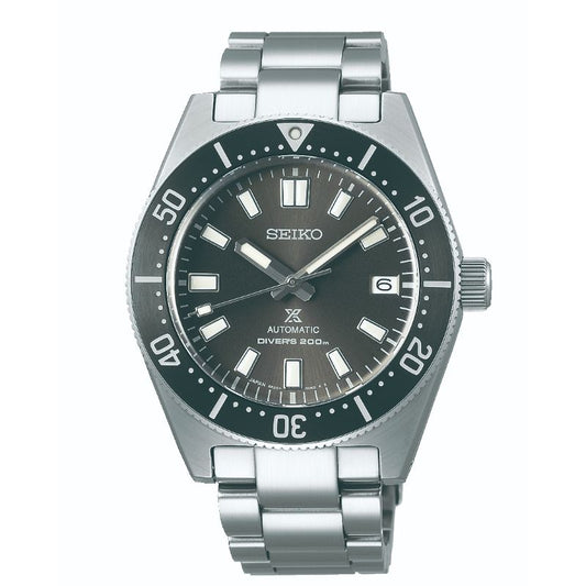 The Seiko Prospex Sea Automatic with Manual Winding 40.5mm Watch features a sleek silver design and a metal band. It includes a dark gray dial, luminescent hour markers, and a convenient date window at the 3 o'clock position. The bezel is detailed with minute indicators, reflecting Seiko's cutting-edge technology.