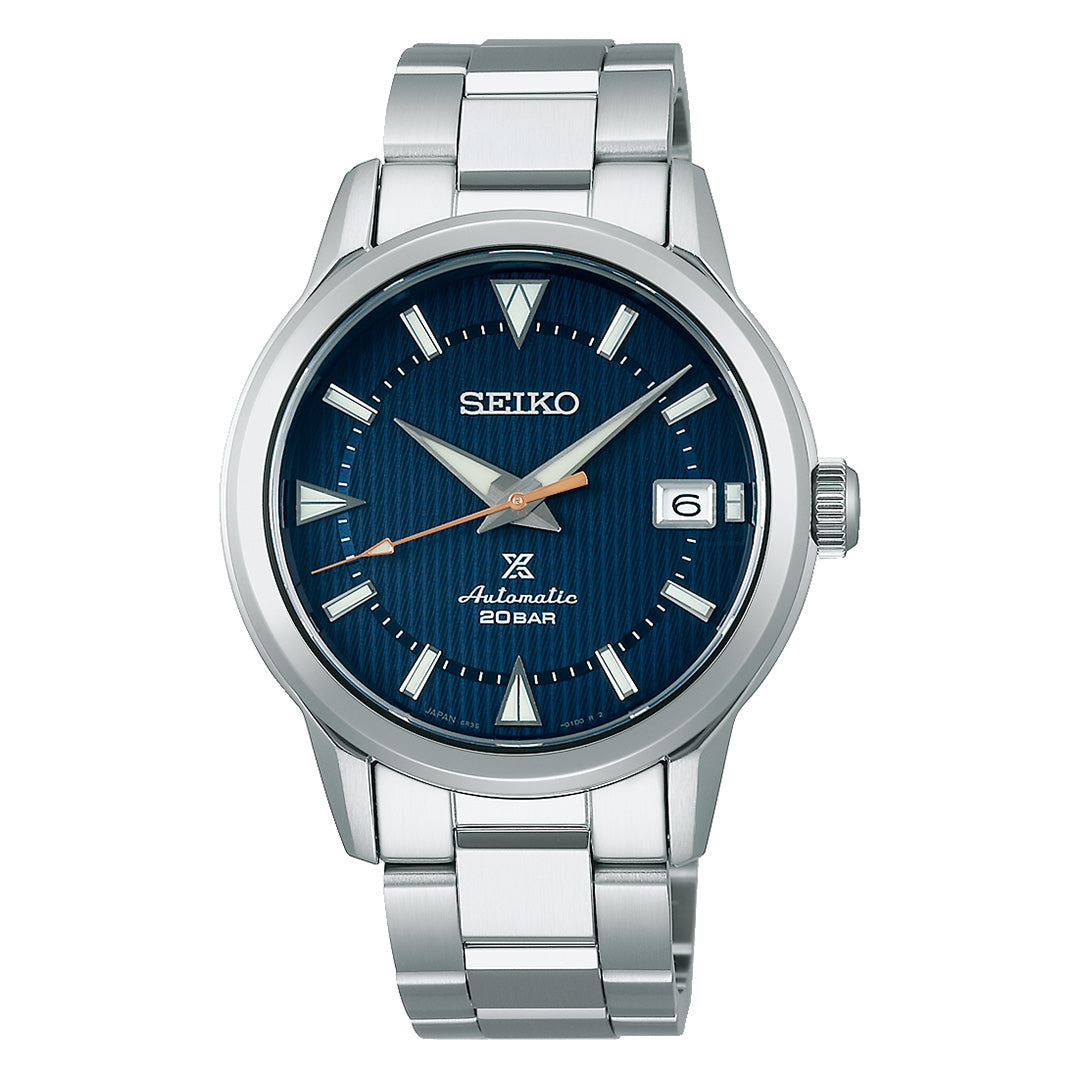 The Seiko Prospex Land Automatic With Manual Winding 38mm Watch by Seiko features a stainless steel case, a blue textured dial with silver hour markers, a date display at 3 o’clock, and a metal bracelet. The dial displays “Seiko,” “Automatic,” “20 BAR,” and the iconic Prospex logo.