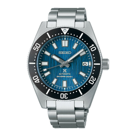 The Seiko Prospex Sea Automatic With Manual Winding 40.5mm Watch, part of the 1965 Diver's Modern Re-interpretation Save the Ocean Special Edition, features a stainless steel band and an eye-catching blue dial. It is equipped with bold hour markers, a date window at the 3 o'clock position, and a rotating diving bezel. Powered by the automatic Caliber 6R35 movement, it offers water resistance up to 200 meters.