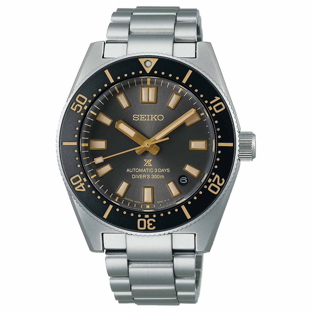 A Seiko Prospex Sea 100th Anniversary diver's watch featuring a stainless steel strap, black bezel, and gray dial is equipped with bold gold-tone hour markers and hands. It includes a date window at the 3 o'clock position and is marked "Automatic 3 Days Diver's 300m," emphasizing its status as a special edition.