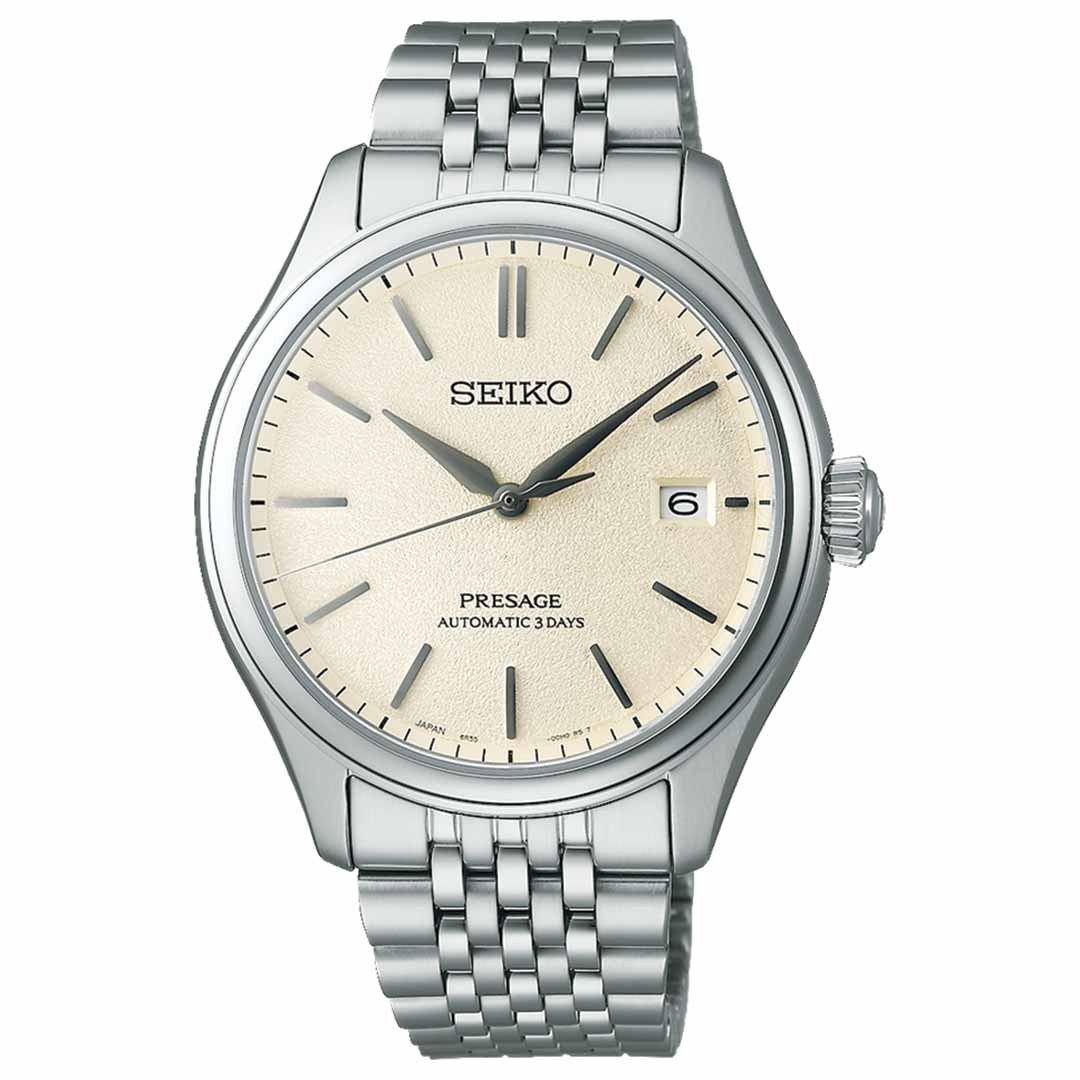 The Seiko Presage Classic Series Automatic With Manual Winding 40.2mm Watch showcases Japanese craftsmanship through its automatic movement. It includes a cream dial with silver hour markers and hands, a date window at 3 o'clock, and is completed with a stainless steel bracelet, resulting in an elegant and timeless design.