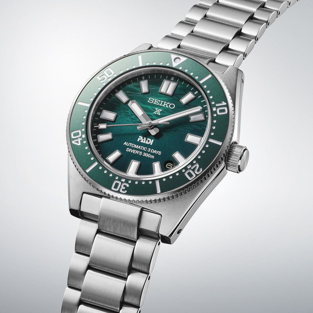 The Seiko Prospex Sea Automatic 40mm Watch by Seiko showcases a vibrant green textured dial with bold white markers and silver hands, complemented by a stainless steel bracelet—all highlighted against a light gray background.