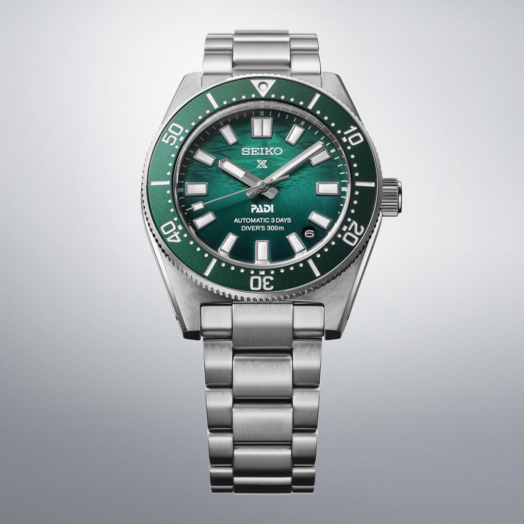 The Seiko Prospex Sea Automatic 40mm Watch by Seiko is showcased with its vibrant green bezel and dial, complemented by silver hour markers, a durable 40mm stainless steel case, and a matching stainless steel bracelet—all photographed against a light gray background.