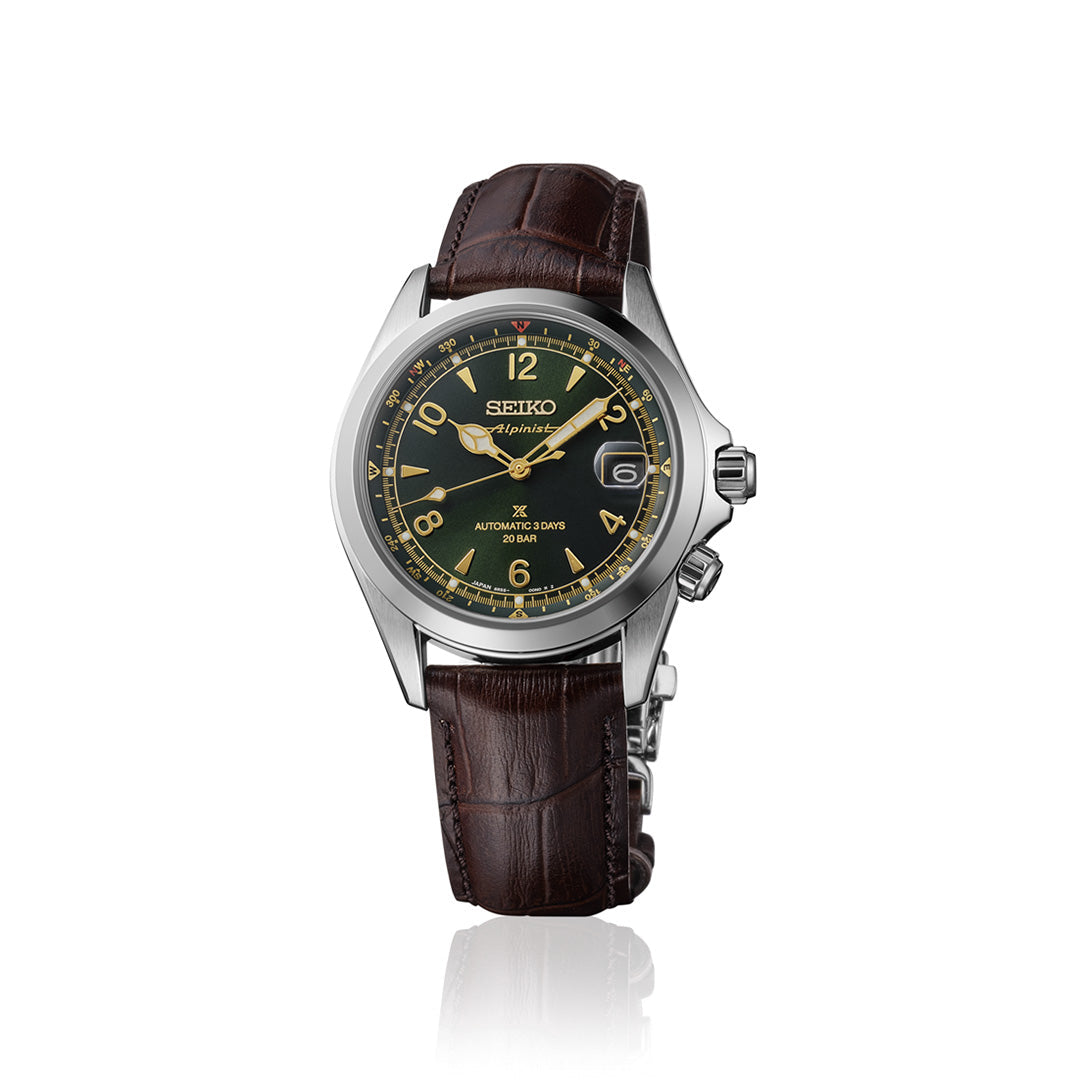 A Seiko Prospex Land Automatic With Manual Winding 39.5mm Watch by Seiko, featuring a stainless steel case, dark green dial with gold accents, and a brown leather strap, is shown upright on a white background.