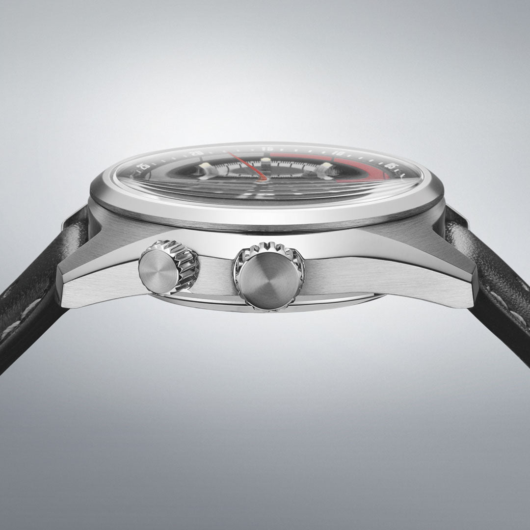 Side view of the Seiko Prospex Speedtimer Datsun 240Z Automatic 39.5mm Limited Edition, showing its silver case, two crown buttons with detailing, and black leather strap against a gray background. Only 2500 pieces made.