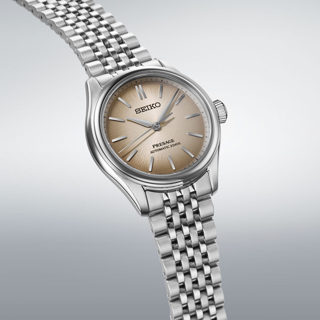 The Seiko Presage Classic Series Automatic With Manual Winding 41mm Watch features a stainless steel band and beige gradient dial with silver markers and hands, displayed on a light gray background.