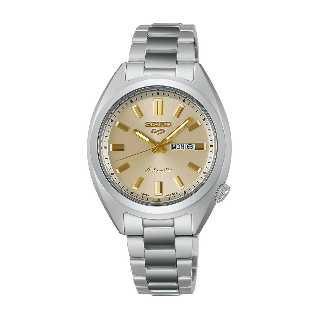 The Seiko 5 Sports SNXS Series Automatic 32mm Watch by Seiko features a stainless steel design, a gold-tone dial with matching gold hour markers and hands, and displays the day and date at the 3 o’clock position. This watch is complemented by a sleek silver metal bracelet.