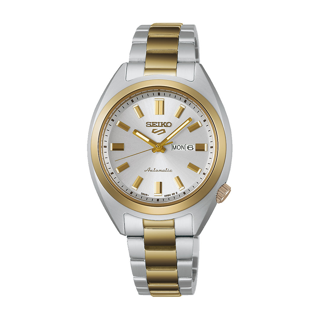 The Seiko 5 Sports SNXS Series Automatic 32mm Watch by Seiko showcases a stainless steel case with a silver and gold metal band, gold hour markers, and a day-date display on its white dial. Combining classic style with dependable functionality, this elegant timepiece is the perfect everyday accessory.