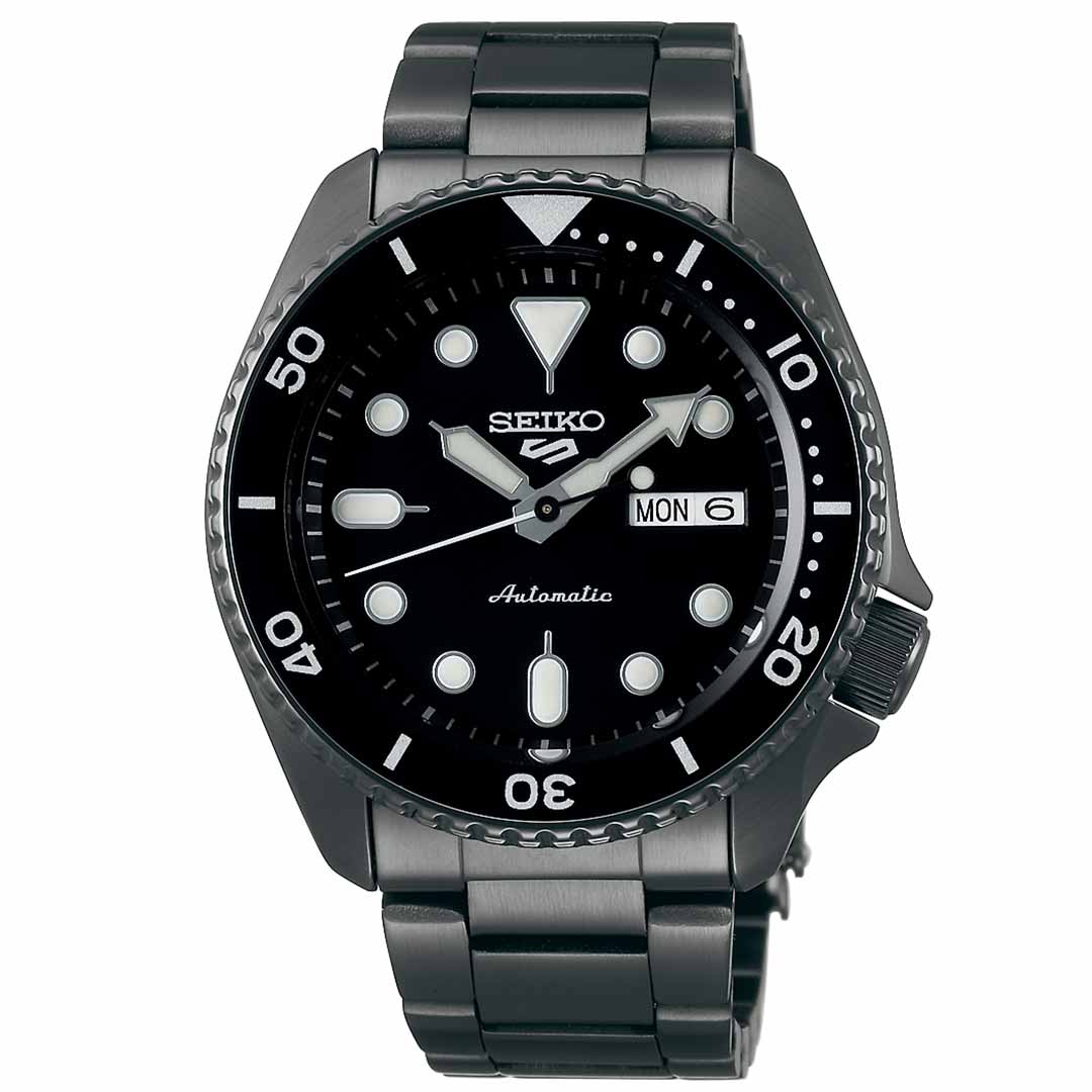 The Seiko 5 Sports SKX Series Automatic 42.5mm Watch boasts an automatic movement and water resistance, featuring a black design with a metal band. It displays the day and date on the right side of the dial, while large white hour markers are enhanced by a rotating bezel that adds an adventurous flair.