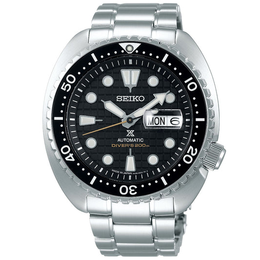 The Seiko Prospex King Turtle Automatic Watch with Manual Winding 45mm showcases cutting-edge design, equipped with a stainless steel bracelet and a black dial featuring white hour markers. It offers a day/date display conveniently positioned at 3 o'clock and includes a unidirectional rotating bezel with minute markers. This watch is water-resistant up to 200 meters.
