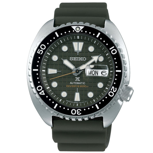 The Seiko Prospex King Turtle Automatic With Manual Winding 45mm Watch features a durable stainless steel case paired with an eye-catching dark green bezel. Its dial showcases prominent luminous markers and hands, along with a day-date display located at the 3 o'clock position. This timepiece is completed with a green silicone strap and offers dependable automatic movement.