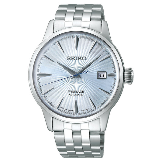 The Seiko Presage Cocktail Time Automatic 40.5mm Watch features a textured light blue dial, silver hour markers, date display at 3 o'clock, and a stainless steel bracelet.