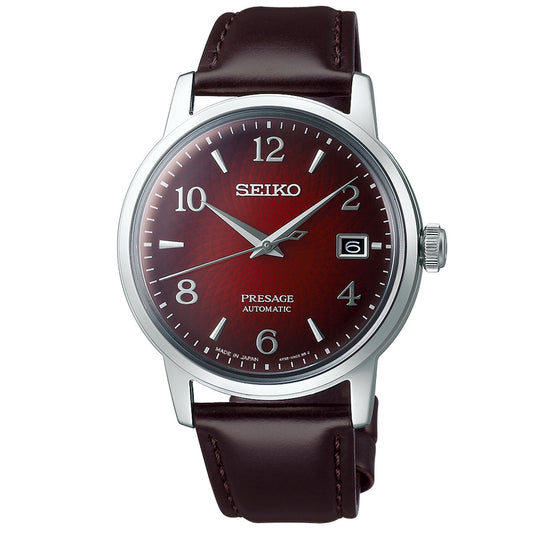 The Seiko Presage Cocktail Time Automatic 38.5mm Watch by Seiko features a stainless steel case complemented by a striking dark red dial. It includes silver-tone hour markers, a date window at the 3 o'clock position, and is paired with a refined brown leather strap, capturing the timeless elegance typical of an automatic watch.