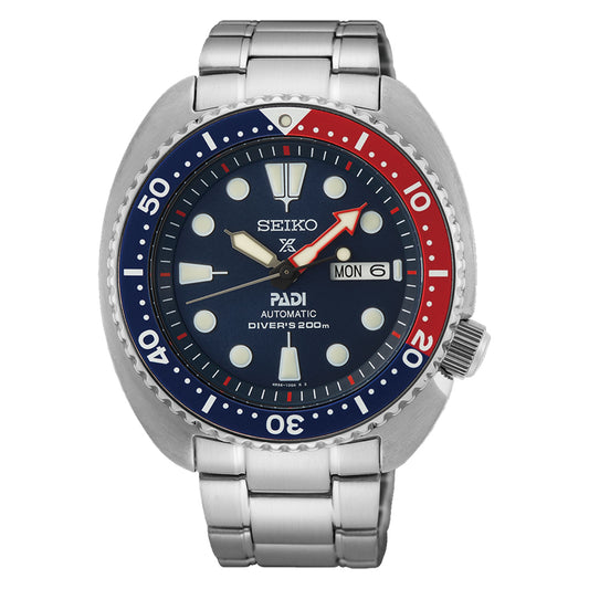 This Seiko Prospex Sea Automatic With Manual Winding 45mm Watch is ideal for adventure enthusiasts, showcasing a blue and red bezel, a navy blue dial, and white markers. It prominently features the day and date display alongside Seiko's logo and the "PADI Automatic Divers 200m" inscription. Its metal bracelet strap enhances its durable design.