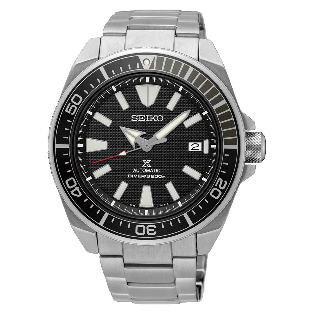 The Seiko Prospex Sea Automatic with Manual Winding 43.8mm features a stainless steel case, black textured dial with bold white hour markers, date at 3 o’clock, black bezel with minute markings, and a silver metal bracelet.
