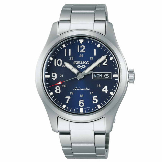 The Seiko 5 Sports Field Series Automatic 39.3mm Watch by Seiko features a sleek silver design with a stainless steel bracelet. Its dark blue dial includes white numerals and showcases the day and date on the right, highlighted by silver hands and a red-tipped second hand.