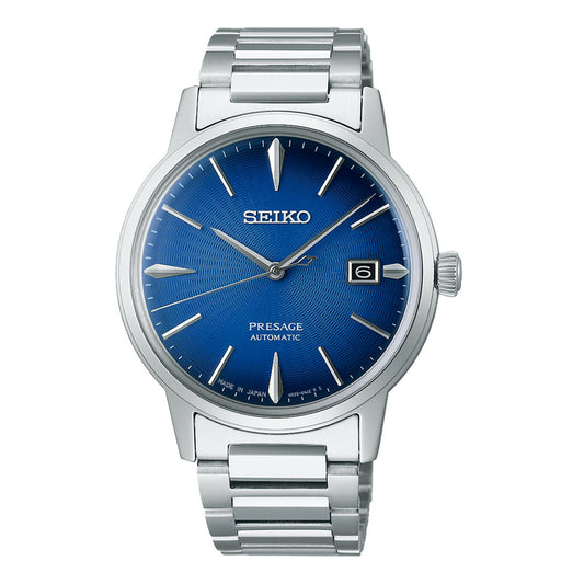 The Seiko Presage Automatic With Manual Winding 39.5mm Watch beautifully embodies the Japanese aesthetic with its silver design and stainless steel strap. Its blue dial is accentuated by silver hour markers, a date window positioned at 3 o'clock, and refined silver hands. The intricately detailed dial boasts a sunburst pattern, showcasing Seiko's enduring craftsmanship in mechanical watchmaking.