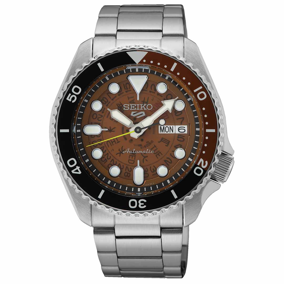 The Seiko 5 Sports SKX Series Automatic 42.5mm Watch, from the renowned brand Seiko, features a stainless steel build with an automatic movement and silver metal bracelet. It has a brown and black dial that includes luminous markers, a day-date display, and a unidirectional black bezel with white numerals.