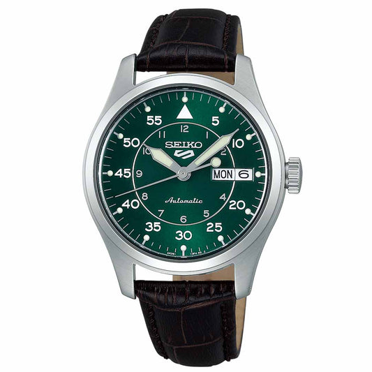 The Seiko 5 Sports Field Series Automatic 36.37mm Watch by Seiko features a green dial with a silver casing and a black leather strap. It includes Arabic numerals, minute markers, and a day-date display positioned at 3 o'clock. The watch operates on an automatic movement system and has silver hands with luminous accents. Combining style and dependability, this watch is also water-resistant.